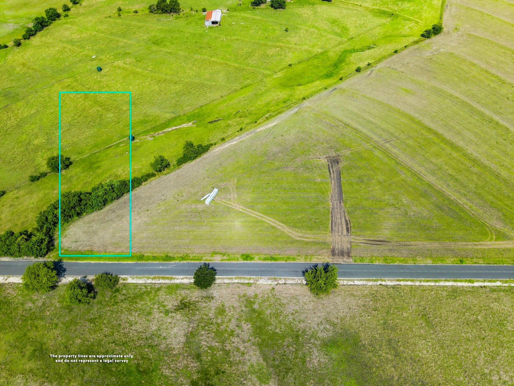 Lush green acreage bordered by a quiet road offer