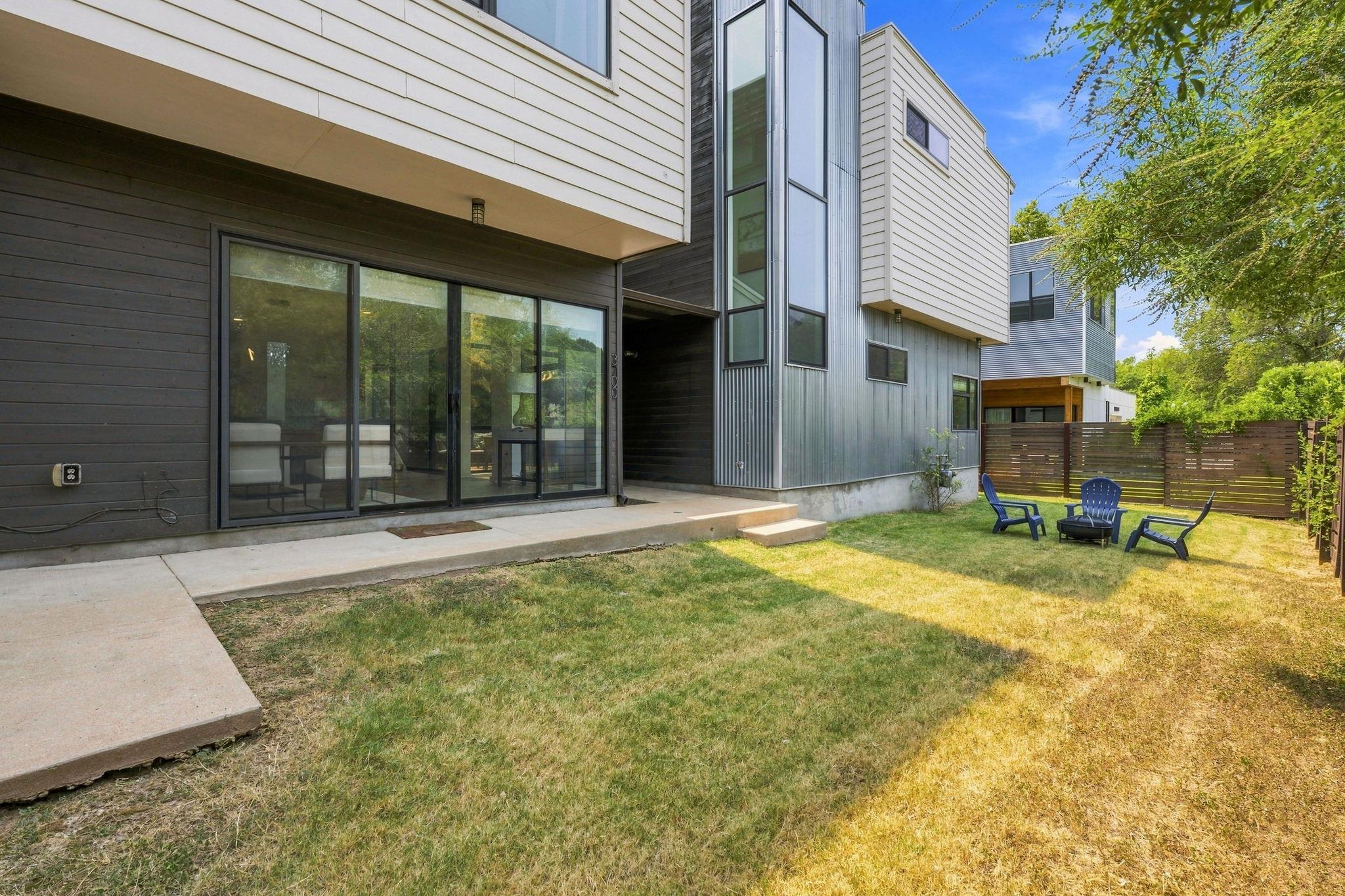 An inviting backyard lawn complements the strikin