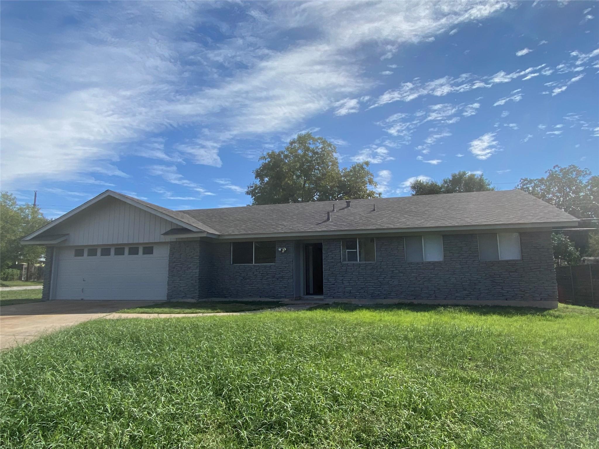 A classic ranch exterior pairs textured stone sid