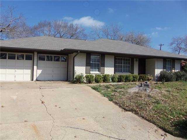 Classic brick accents and a spacious concrete dri