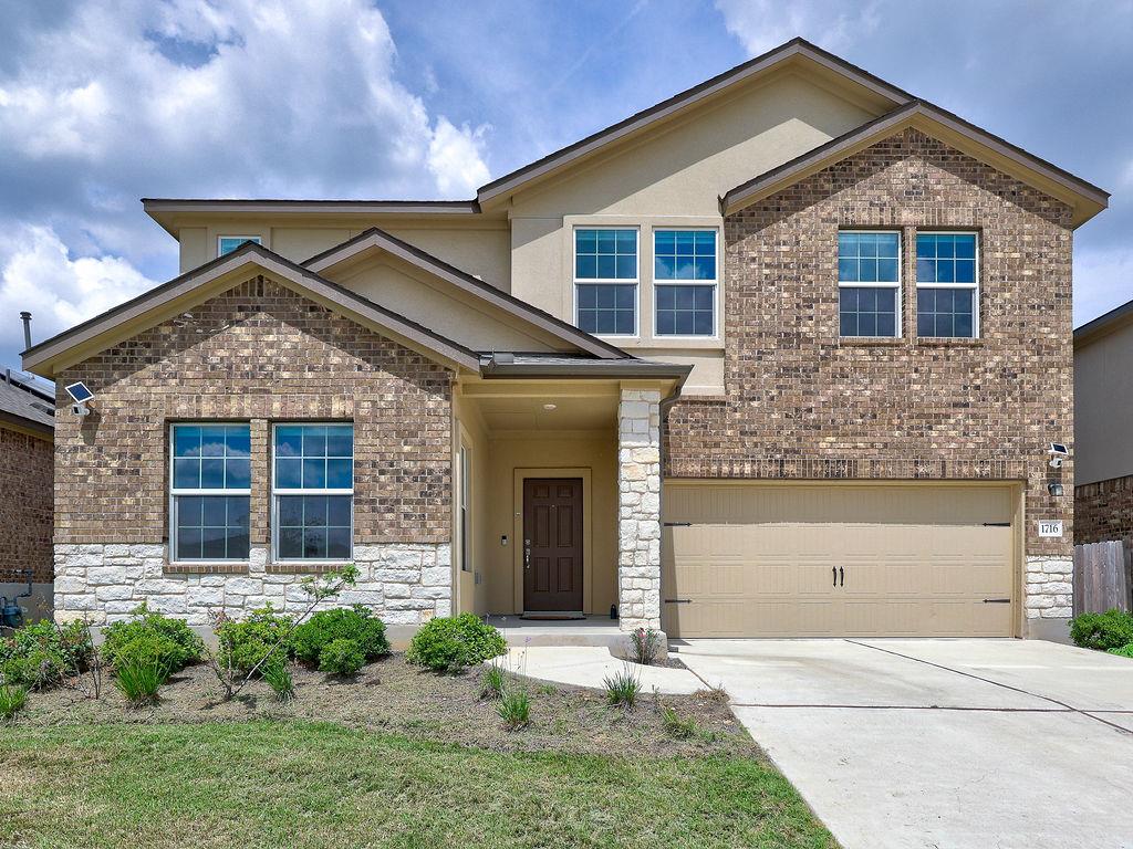 A classic brick and stone facade creates welcomin
