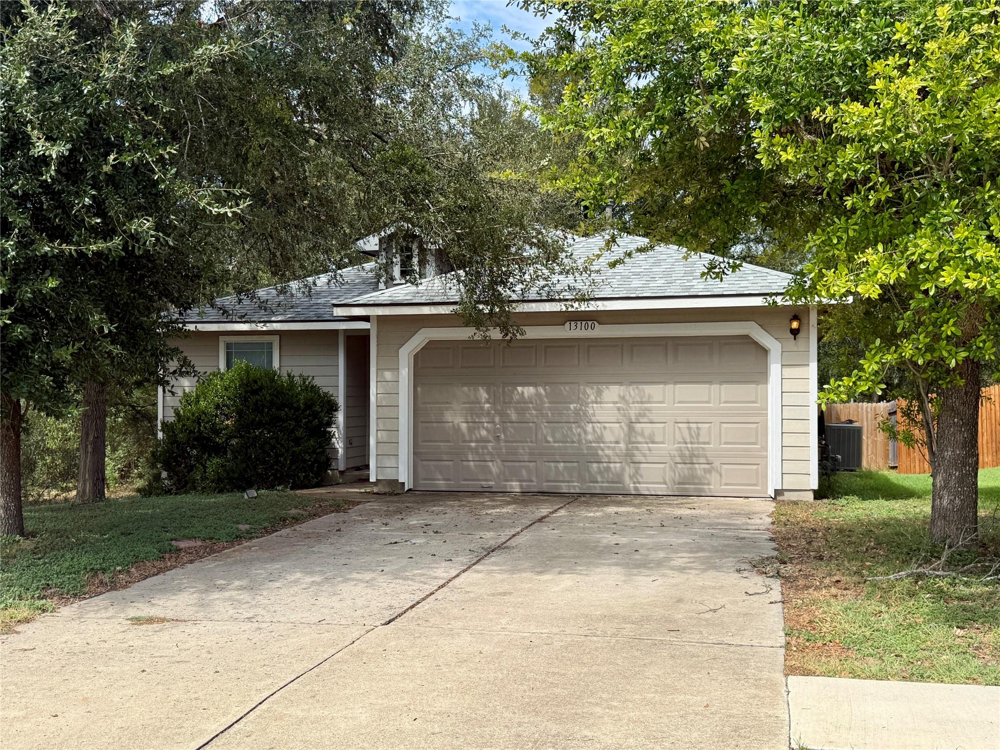 Mature trees shade a classic single-story home fe
