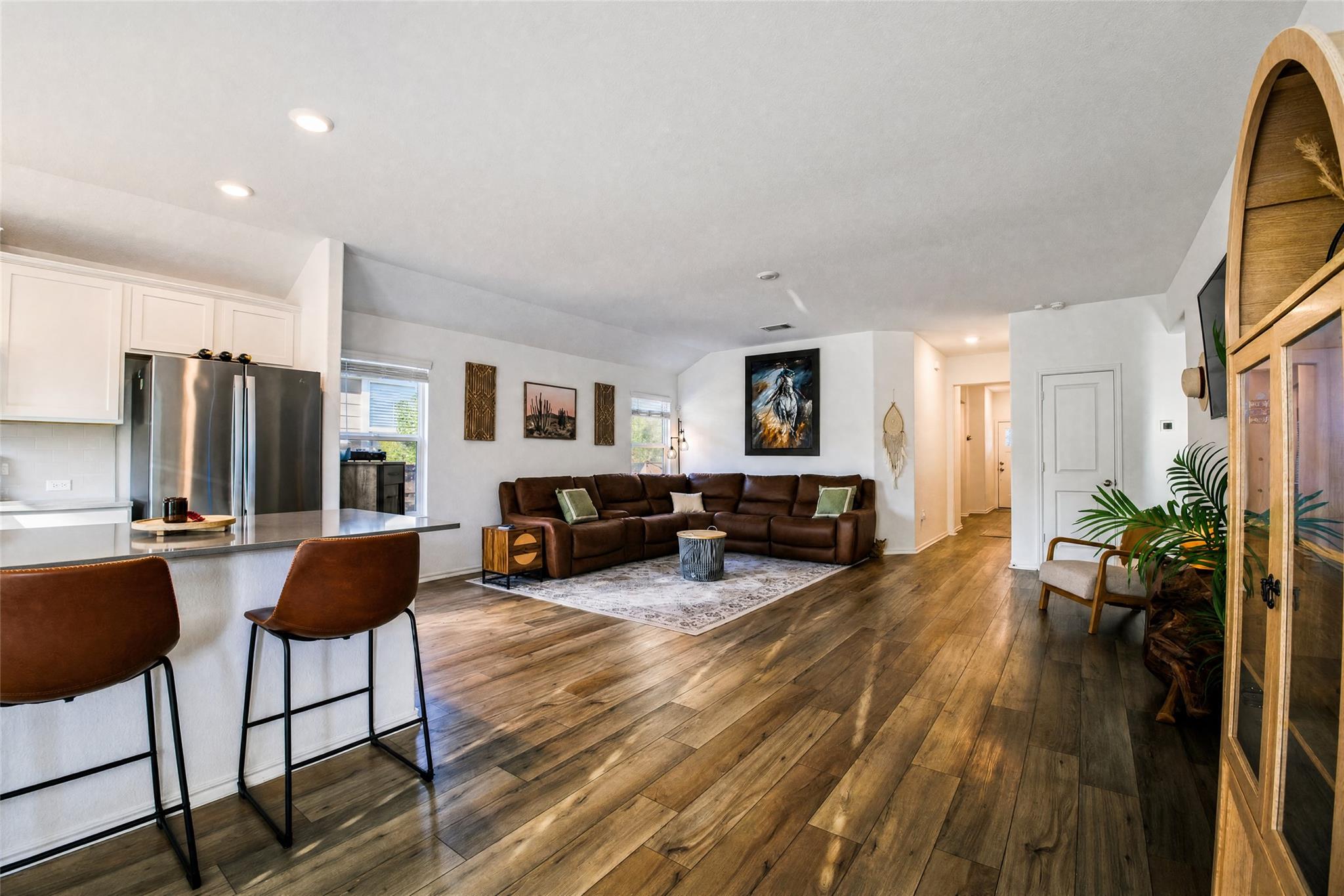 Rich wood-look flooring and recessed lighting def