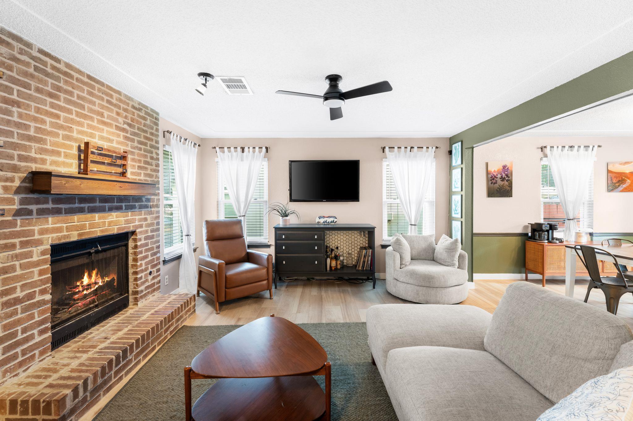 An inviting wood-burning brick fireplace anchors 