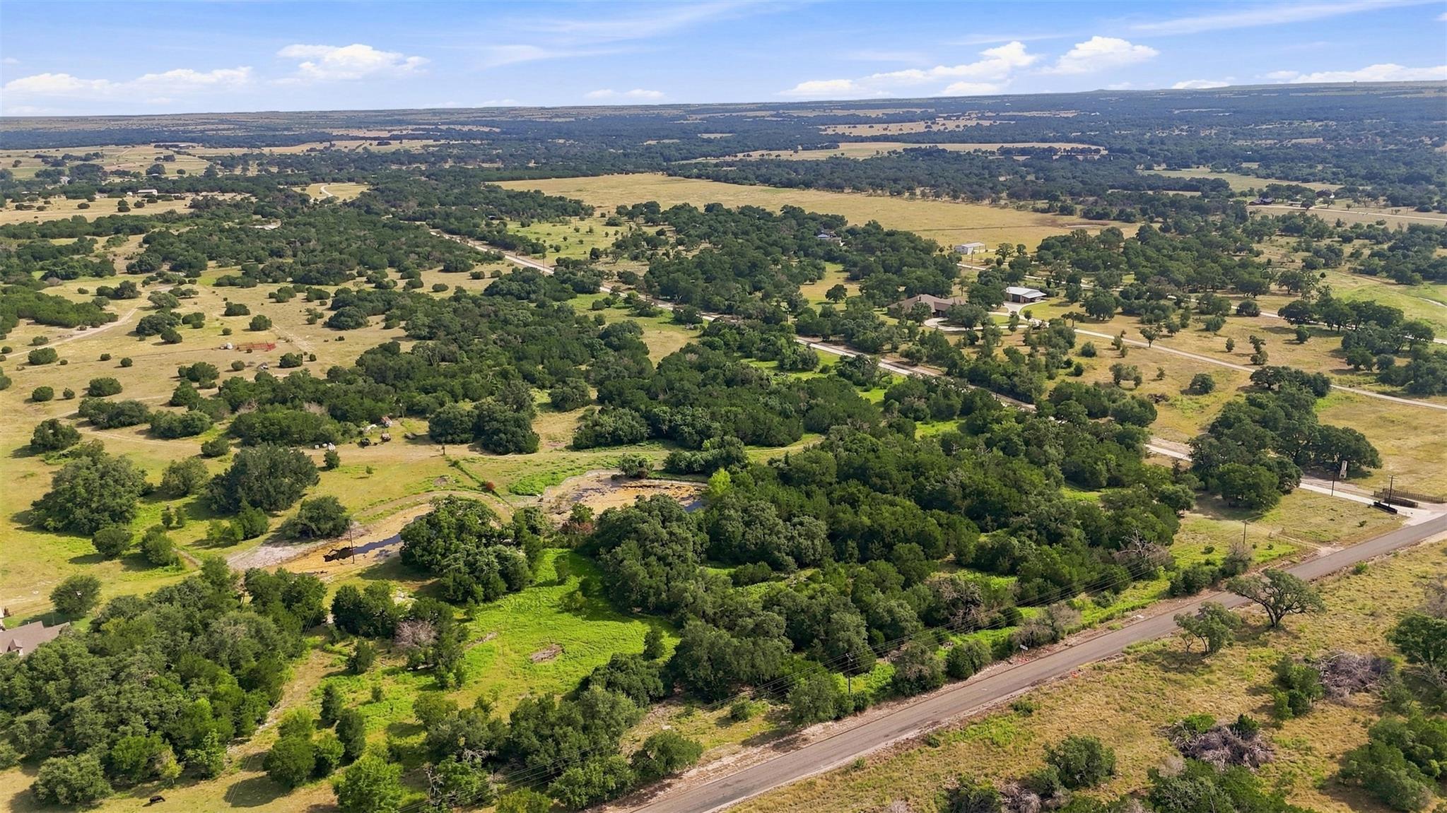Vast acreage features rolling terrain dotted with