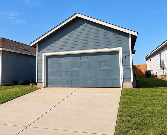 A spacious driveway leads directly to a neat fron
