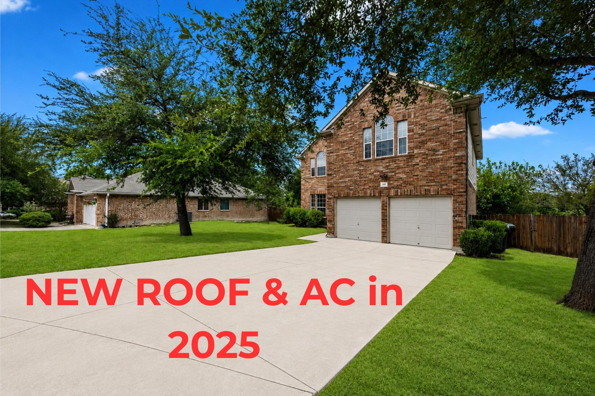 Mature trees shade a wide concrete driveway leadi