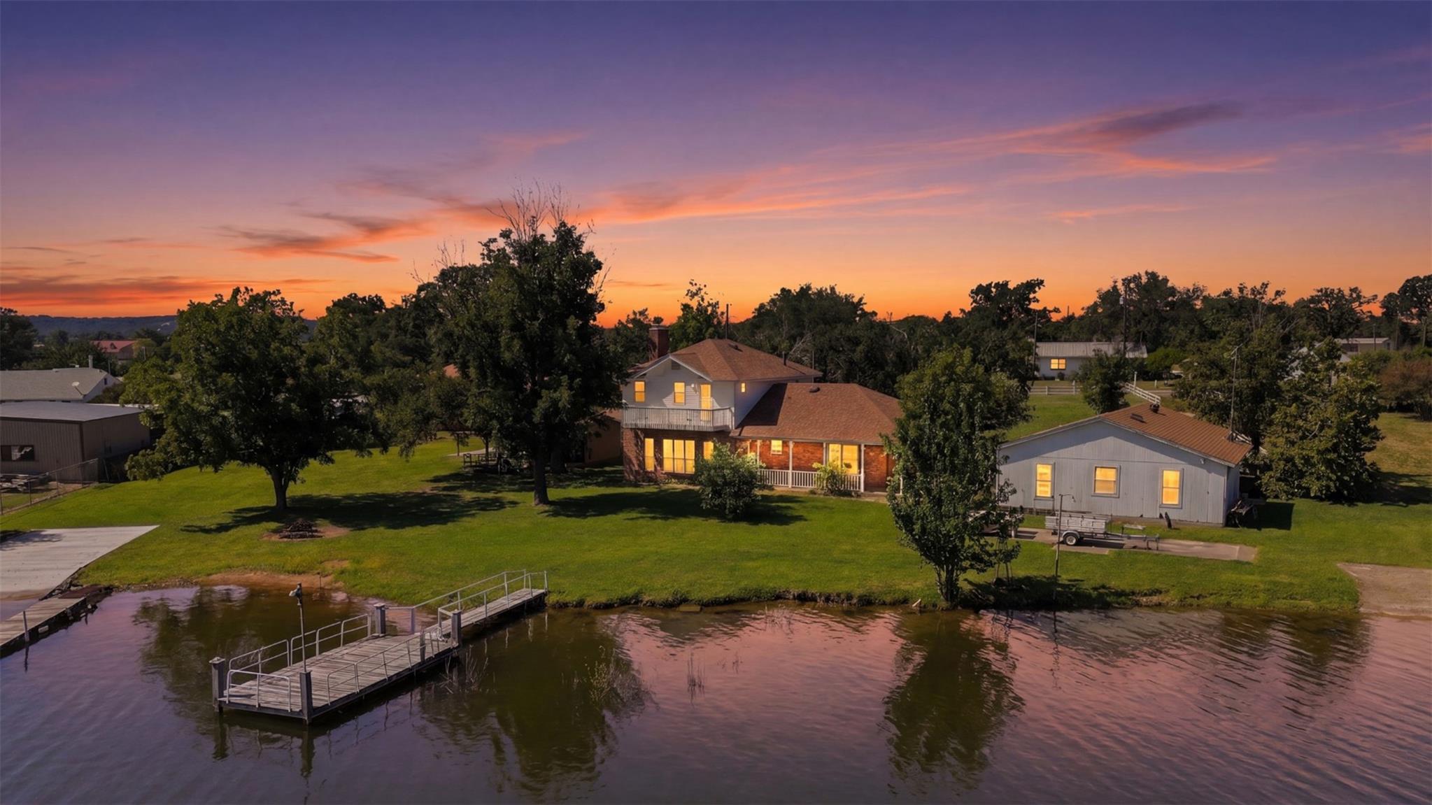 Lawn slopes gently to private water frontage feat