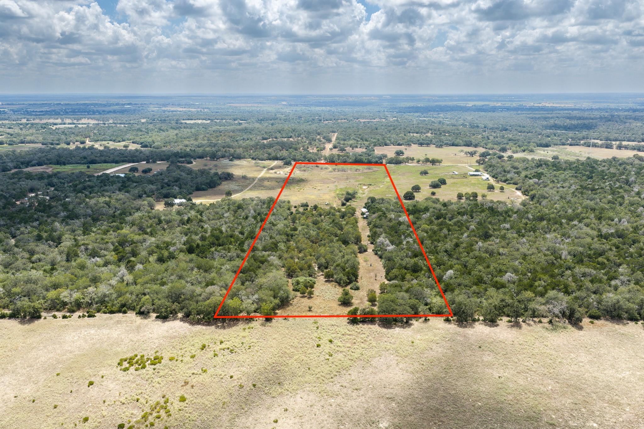 An expansive parcel combines dense tree lines wit