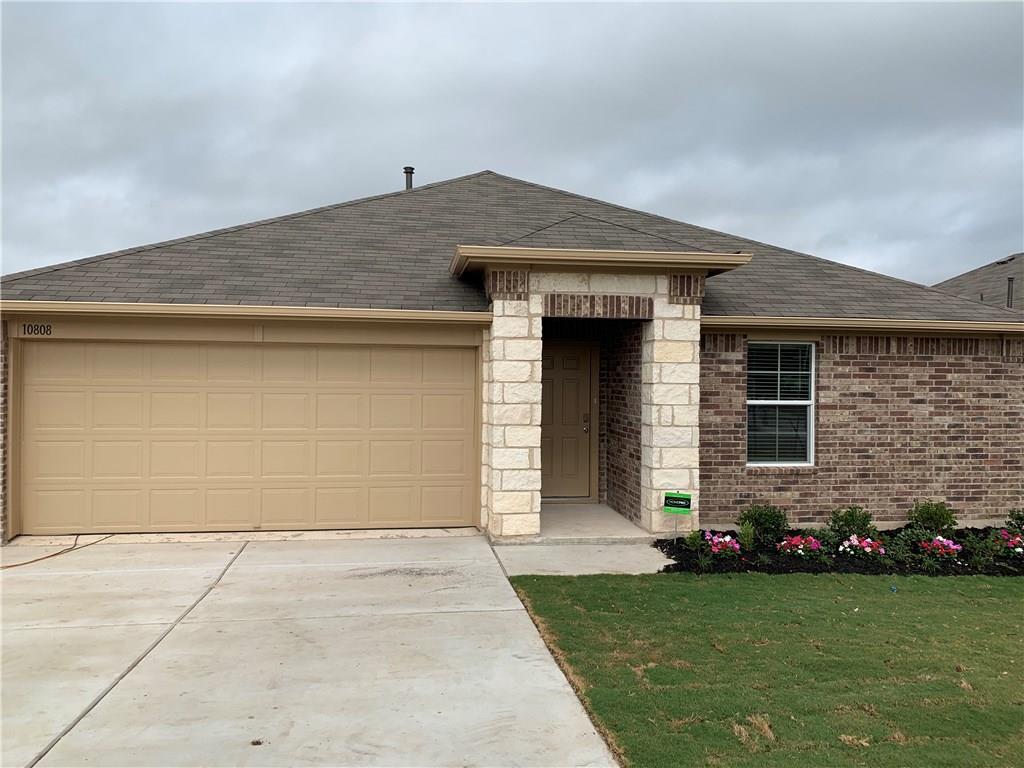 A classic brick exterior and a concrete driveway 