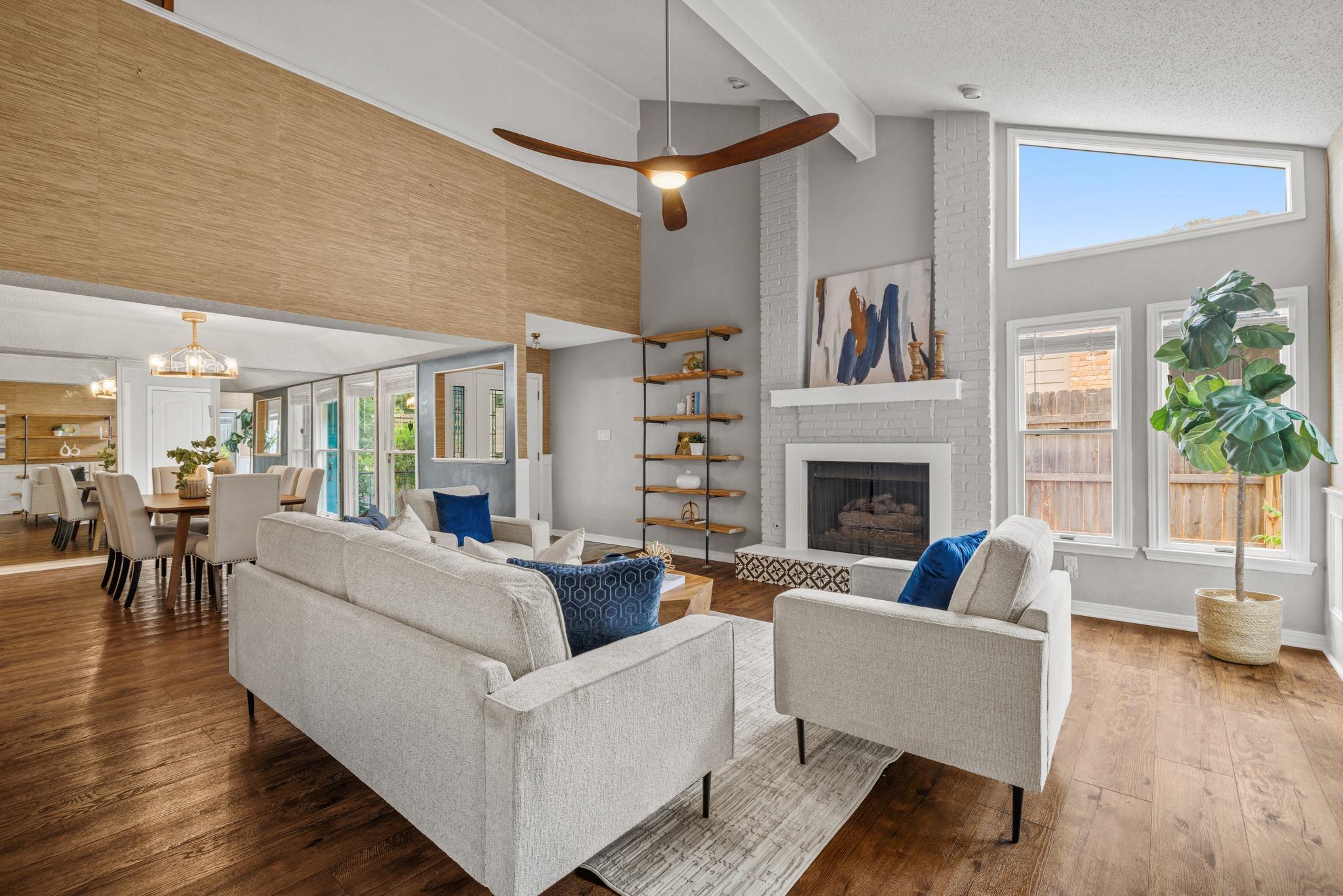 Hardwood floors and a painted brick fireplace hig