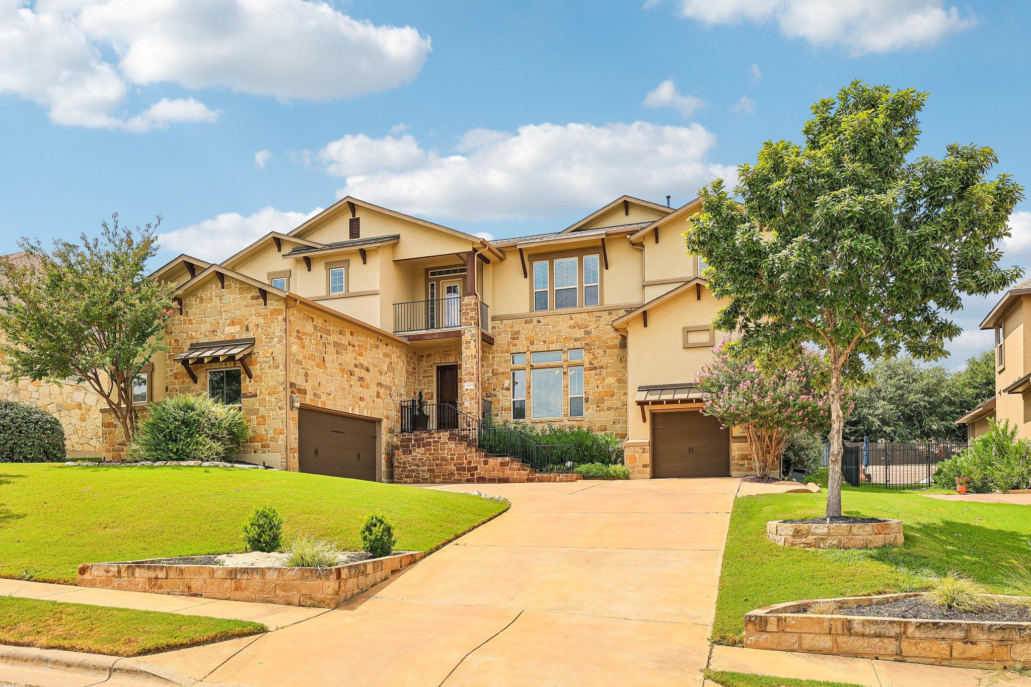 An impressive stone and stucco exterior anchors t