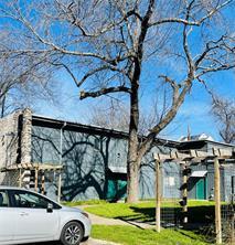 Mature trees shade a welcoming paved pathway lead
