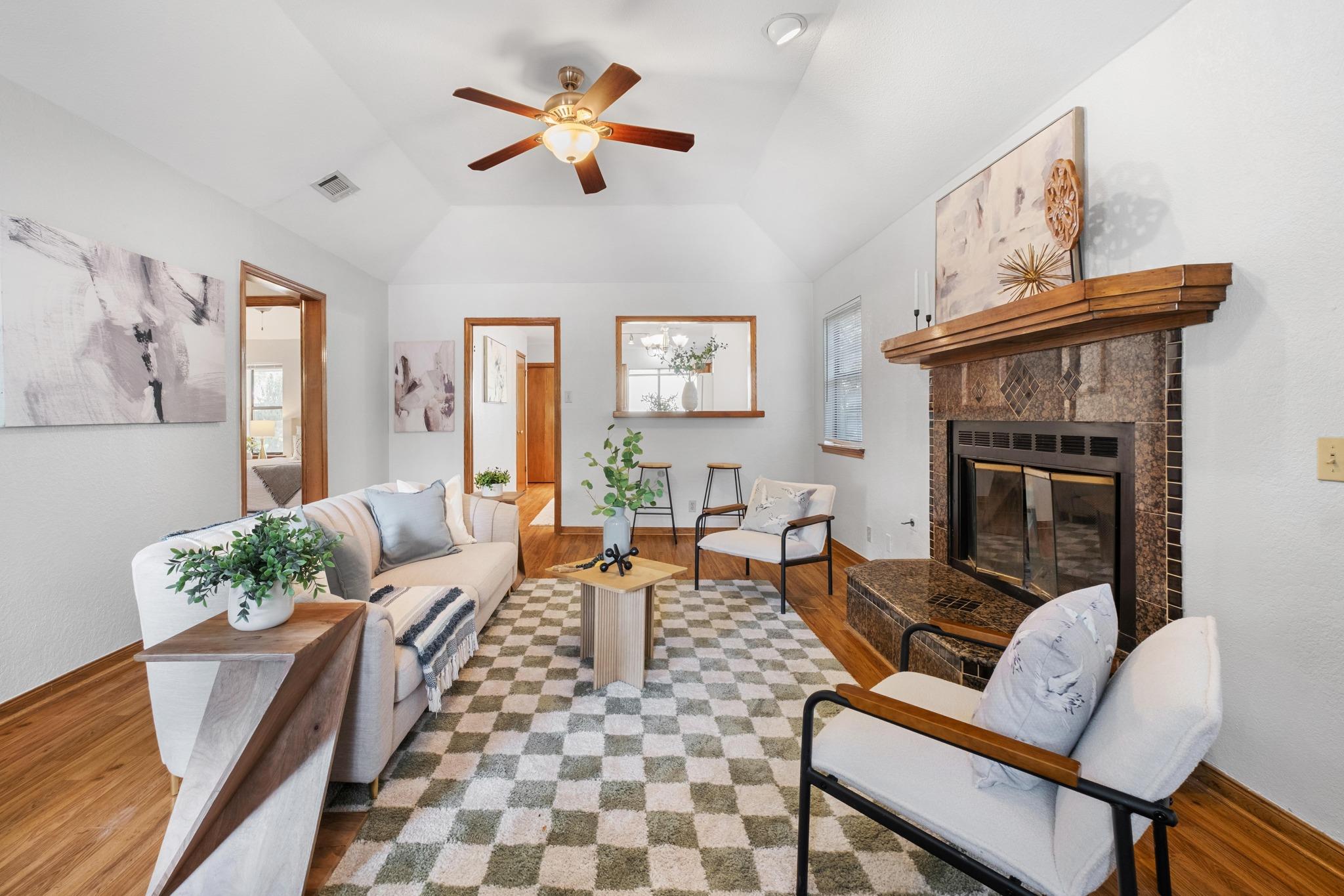 A classic tiled fireplace and vaulted ceilings hi