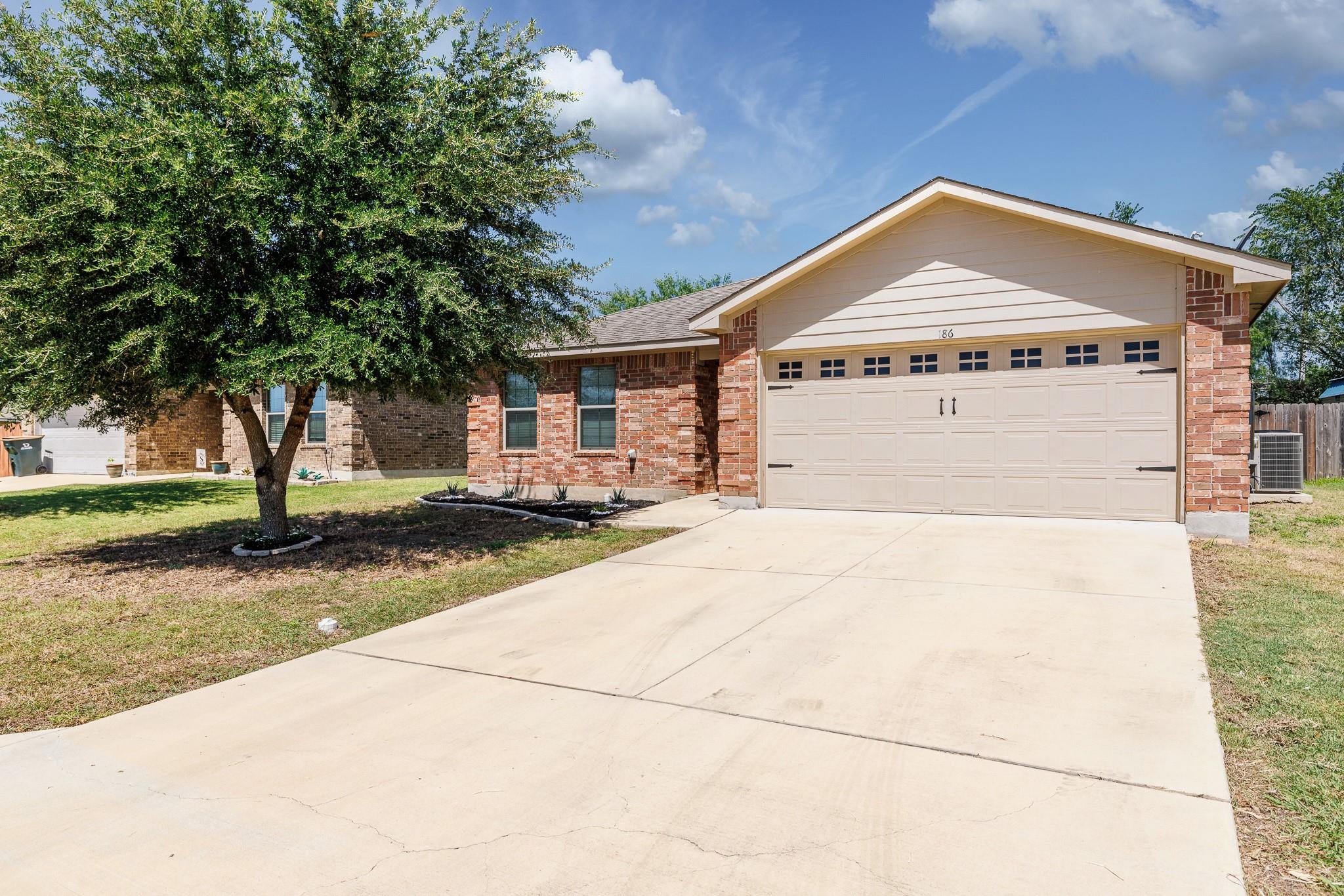 A spacious concrete driveway leads directly to a 