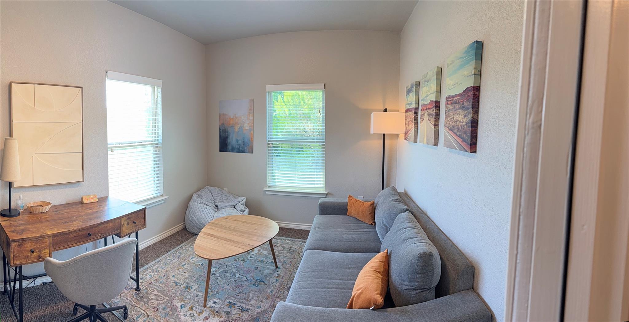 High ceilings and tall windows enhance this comfo