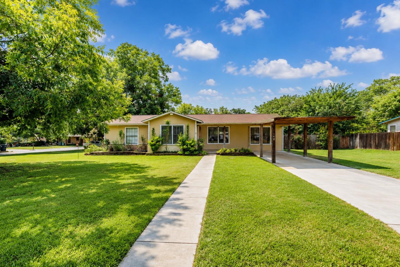 A concrete walkway leads to this single-story hom