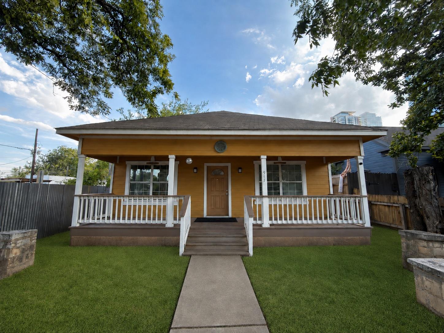 A welcoming front porch and concrete pathway lead