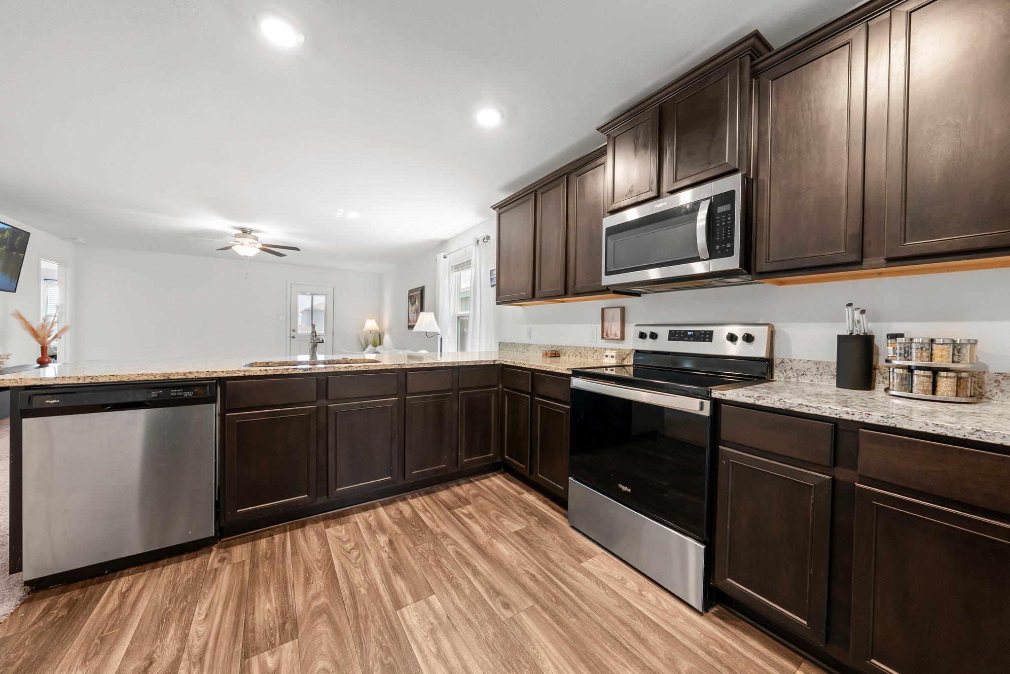 Rich wood cabinetry and expansive granite counter
