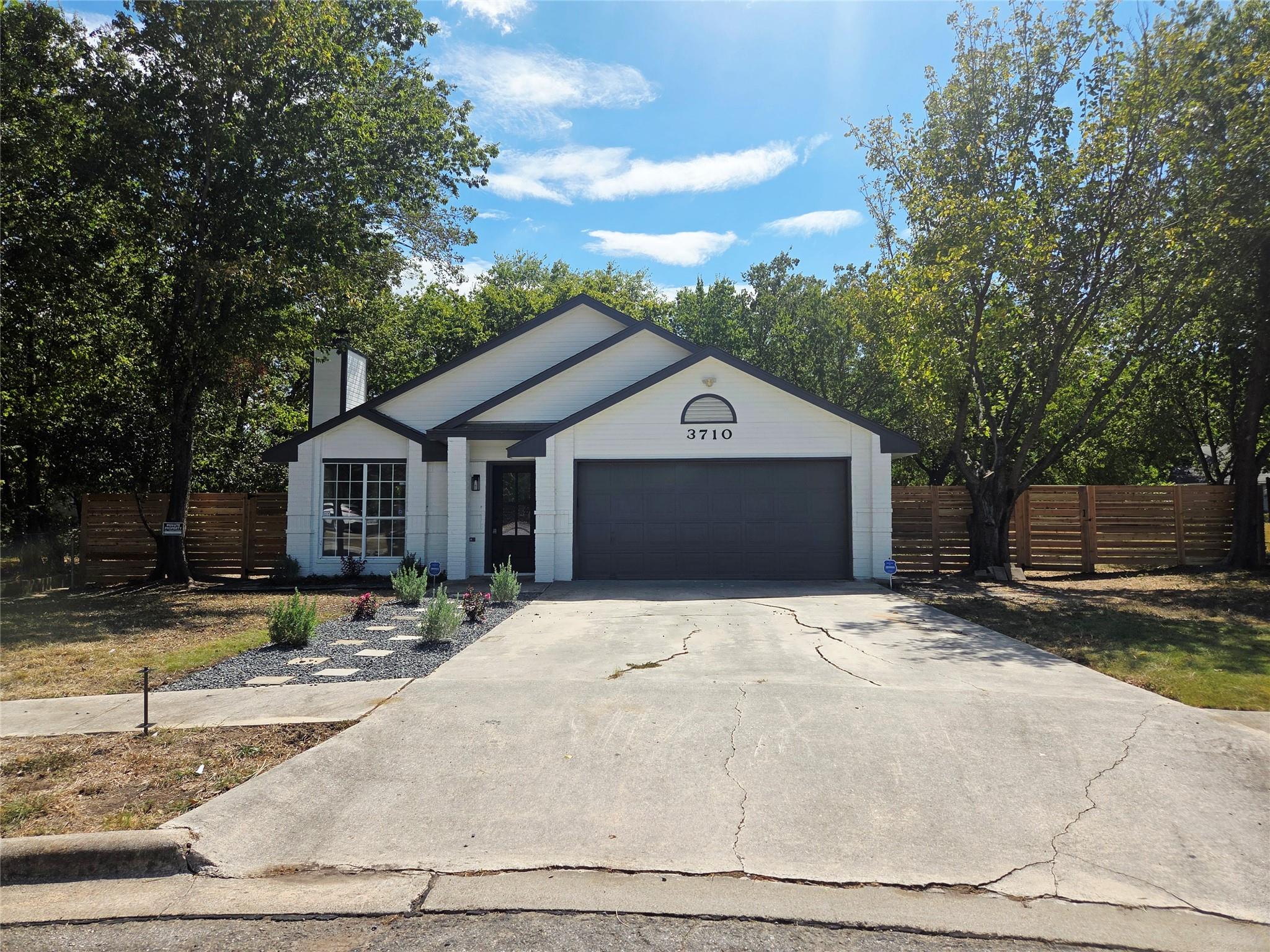A classic concrete driveway leads to a modern ext