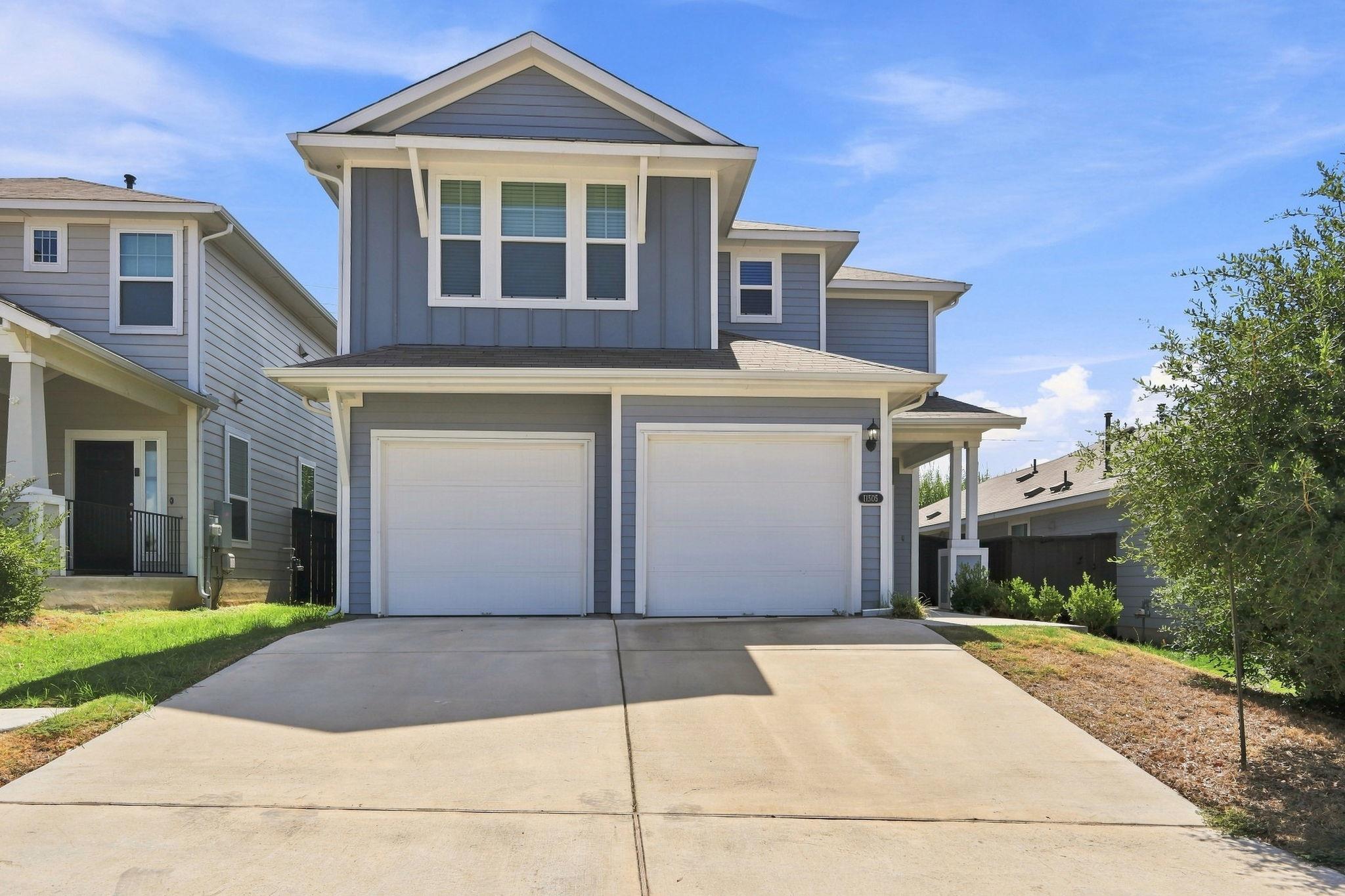 A spacious driveway leads up to this modern two-s