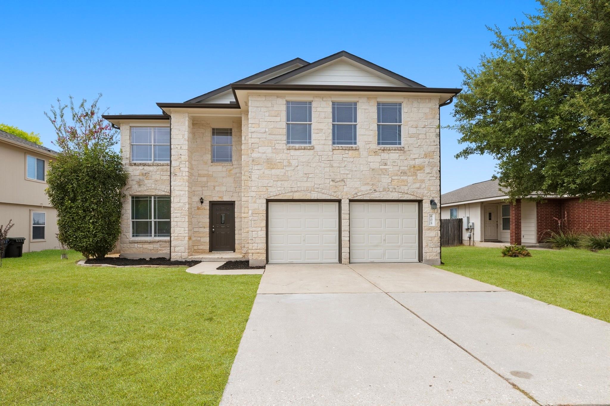 An elegant stone facade highlights this two-story