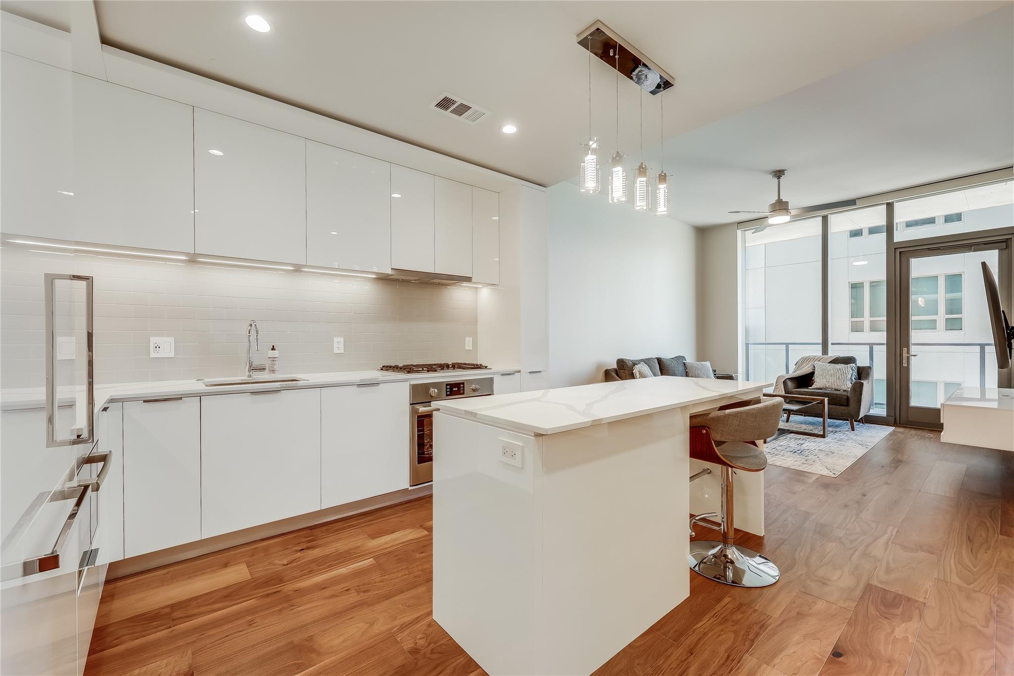 Rich hardwood flooring anchors this modern culina