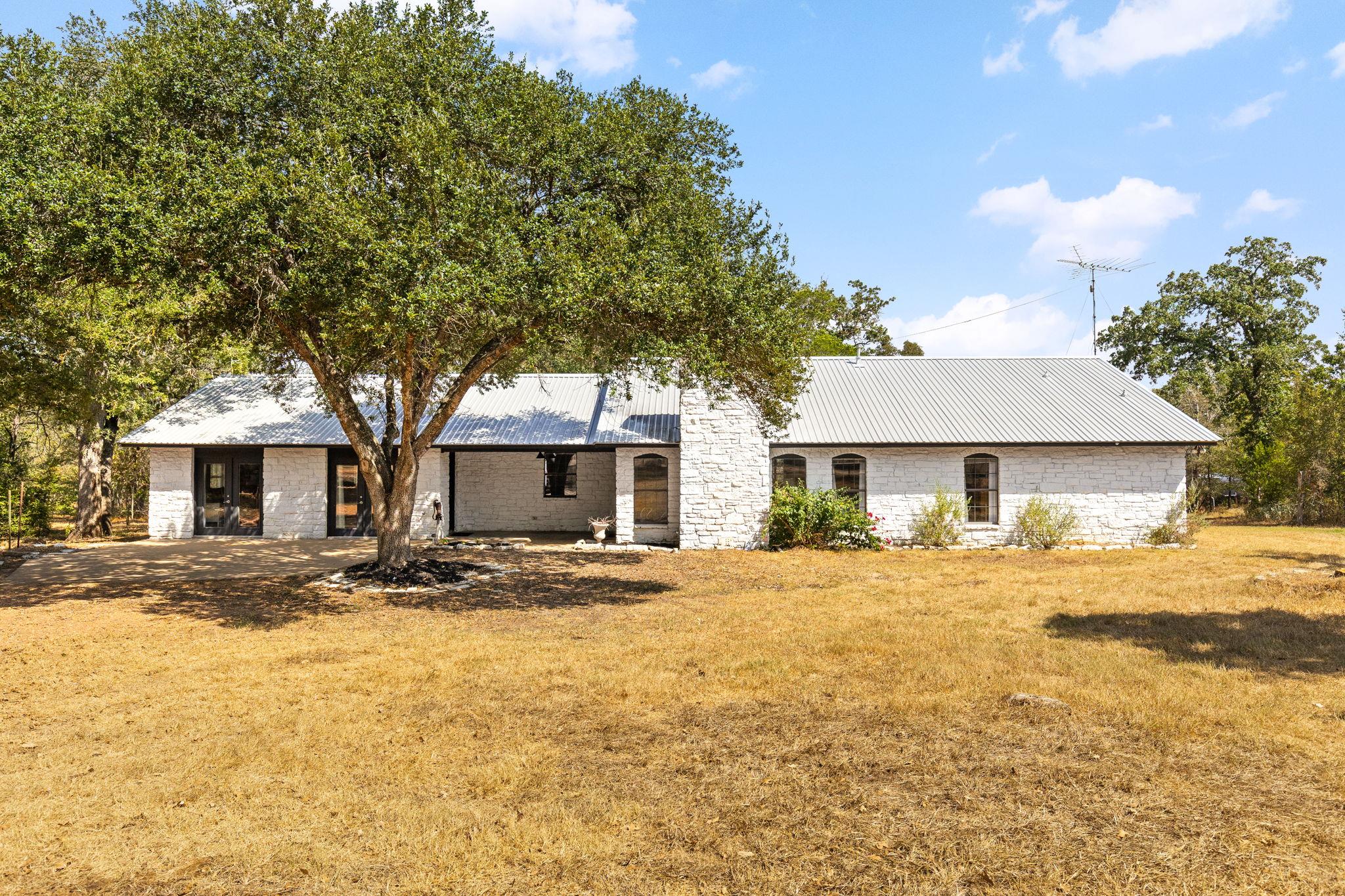 A classic metal roof and textured stone masonry d