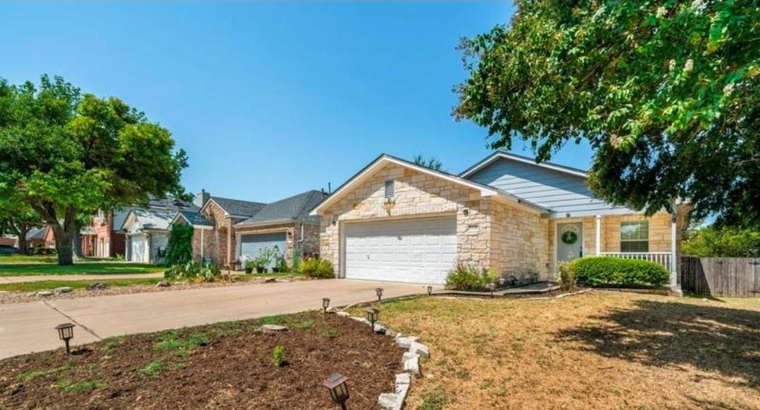 A classic stone exterior and long driveway define