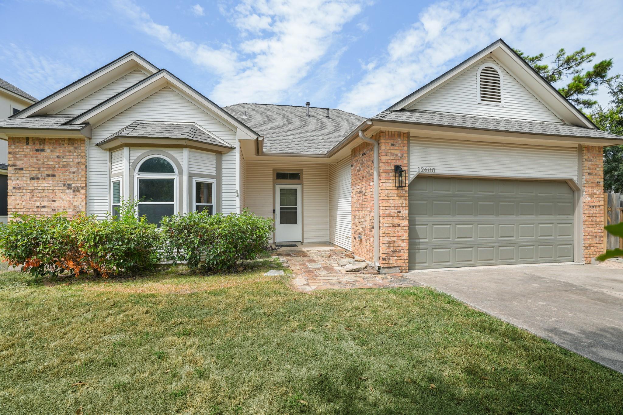 Brick accents and a classic bay window define the