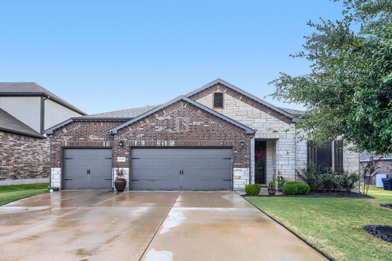 Brick and stone accents define this modern single