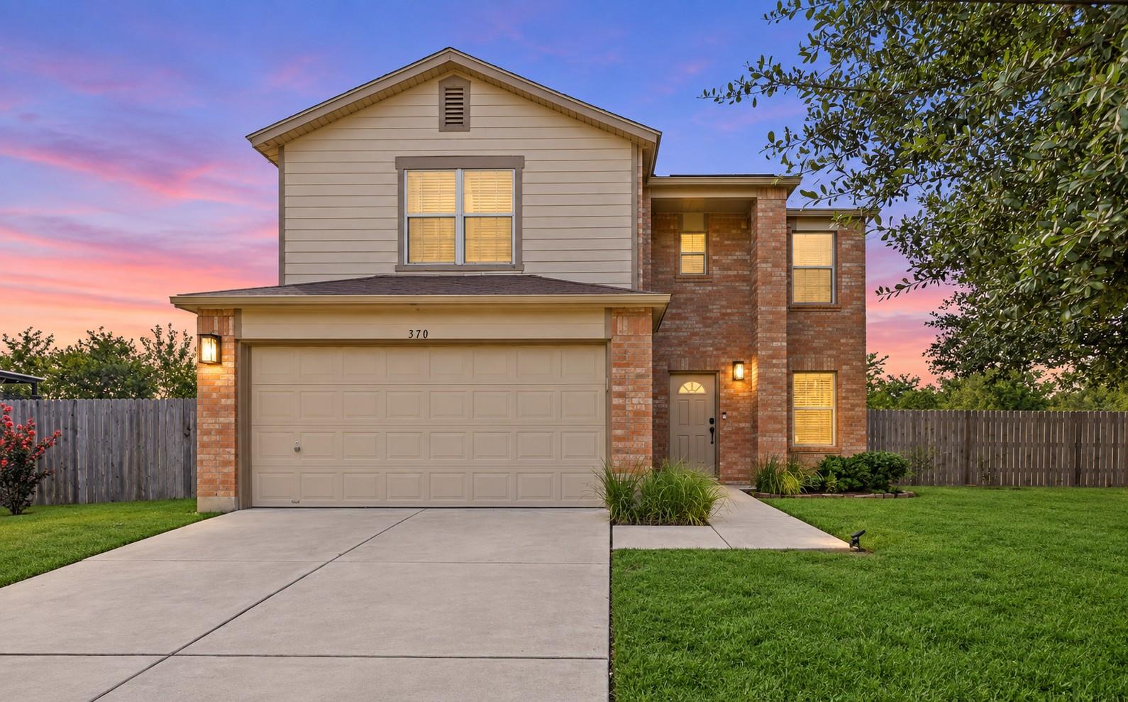 A classic brick and siding exterior features a fr
