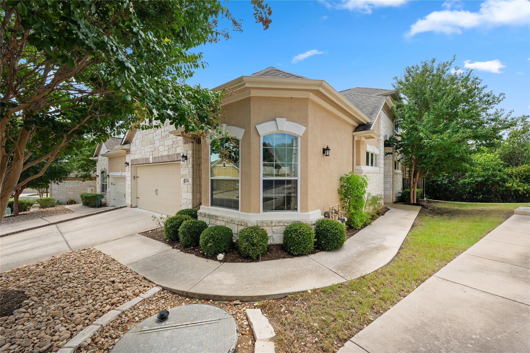 Stucco and stone architectural details pair with 