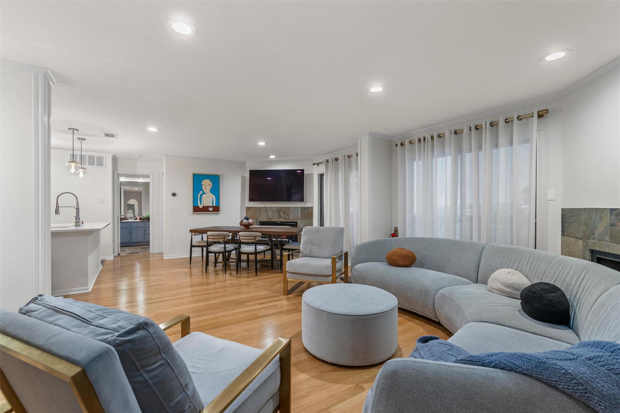 Gleaming hardwood floors and recessed lighting en
