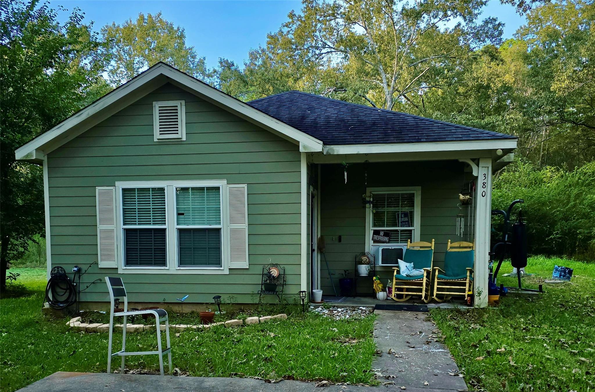 Mature trees frame a classic siding exterior feat