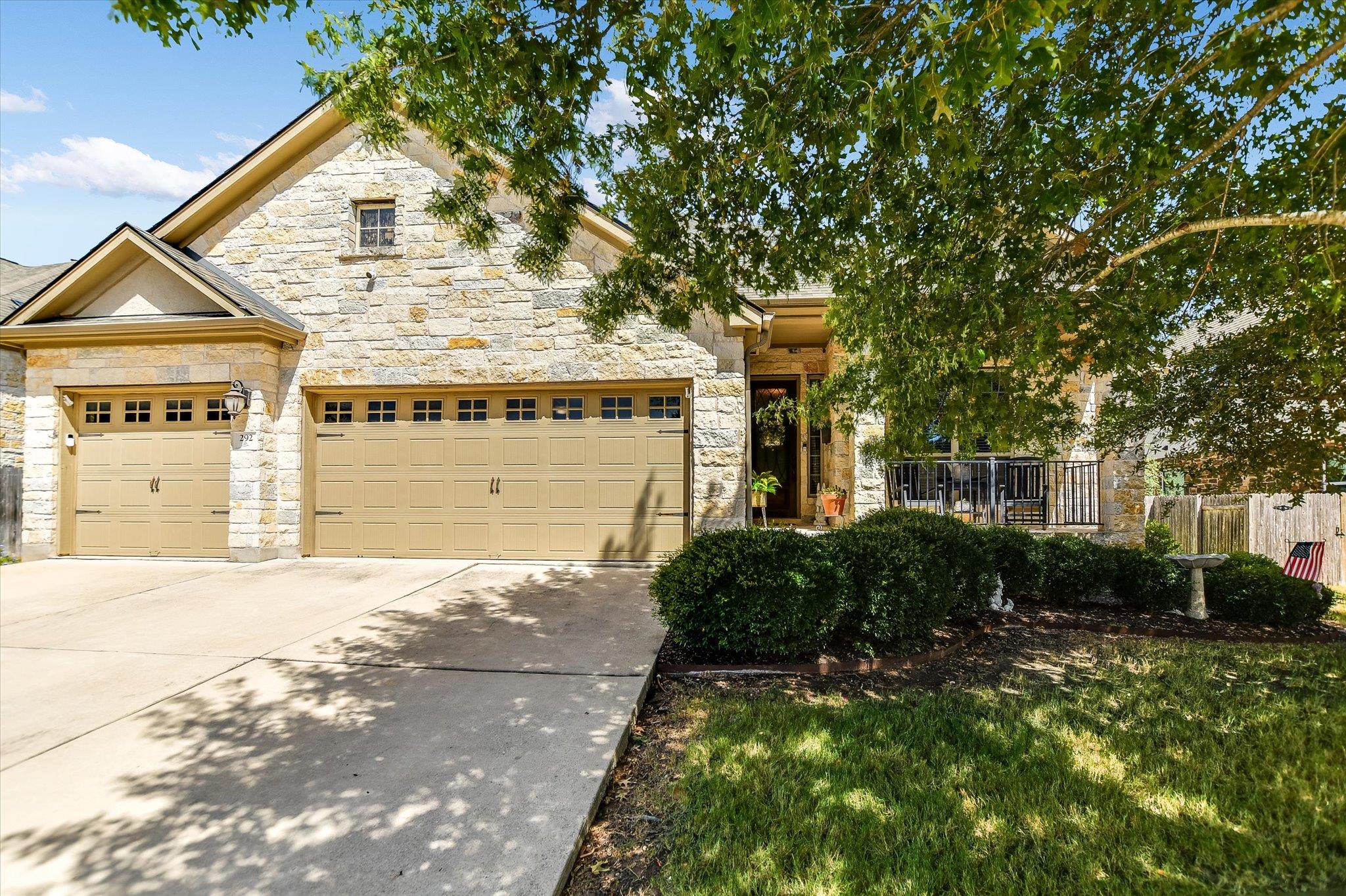 Textured stone veneer and a spacious concrete dri