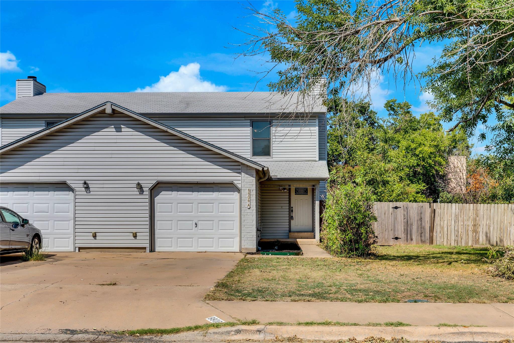 Classic siding and a private garage define this i