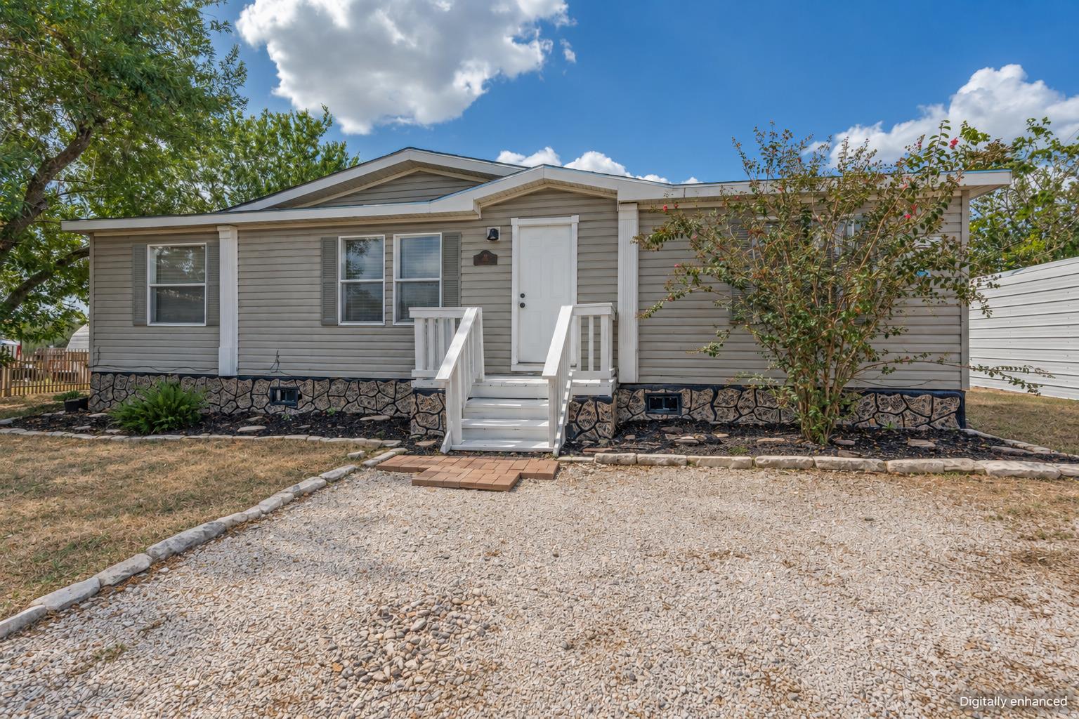 Vinyl siding and stone skirting complement the ex