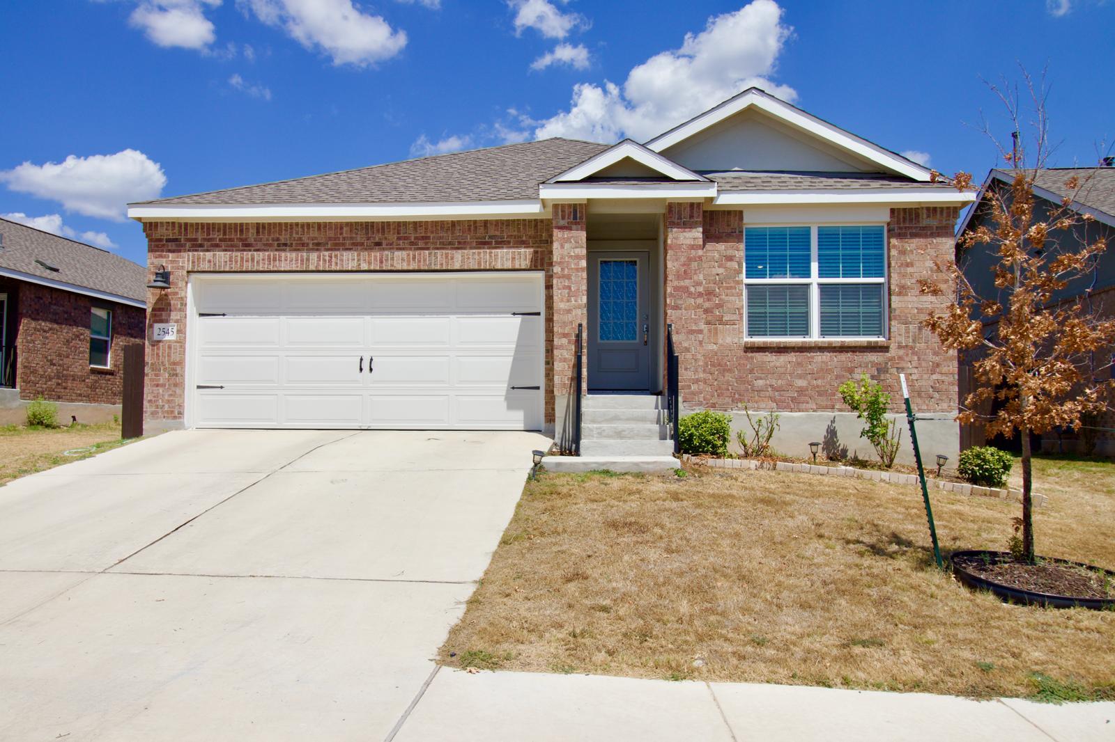 Classic brick craftsmanship and a concrete drivew