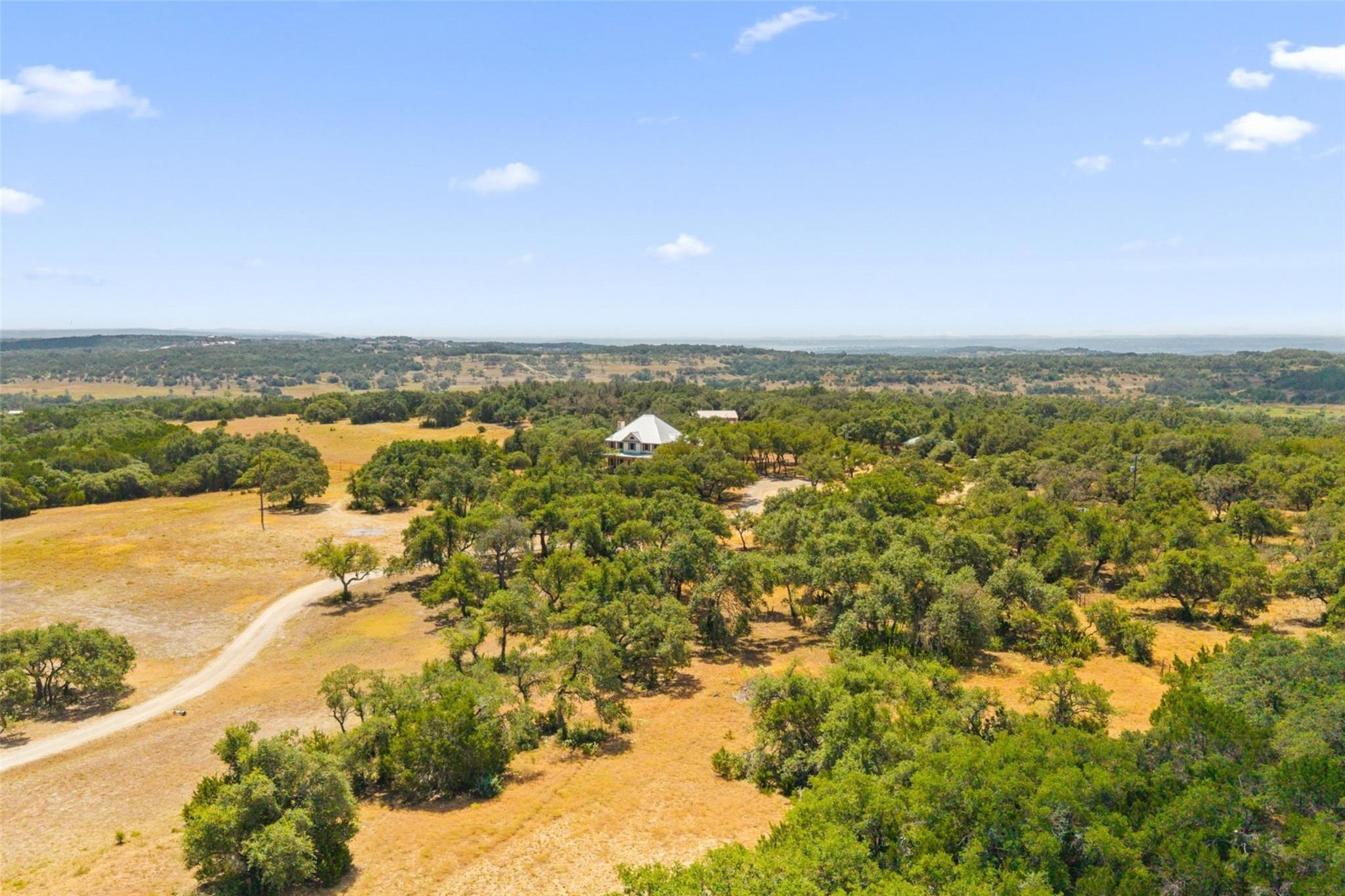 Mature trees and rolling hills cradle this seclud