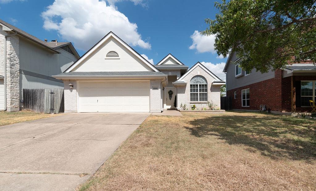 An inviting front elevation showcases classic bri