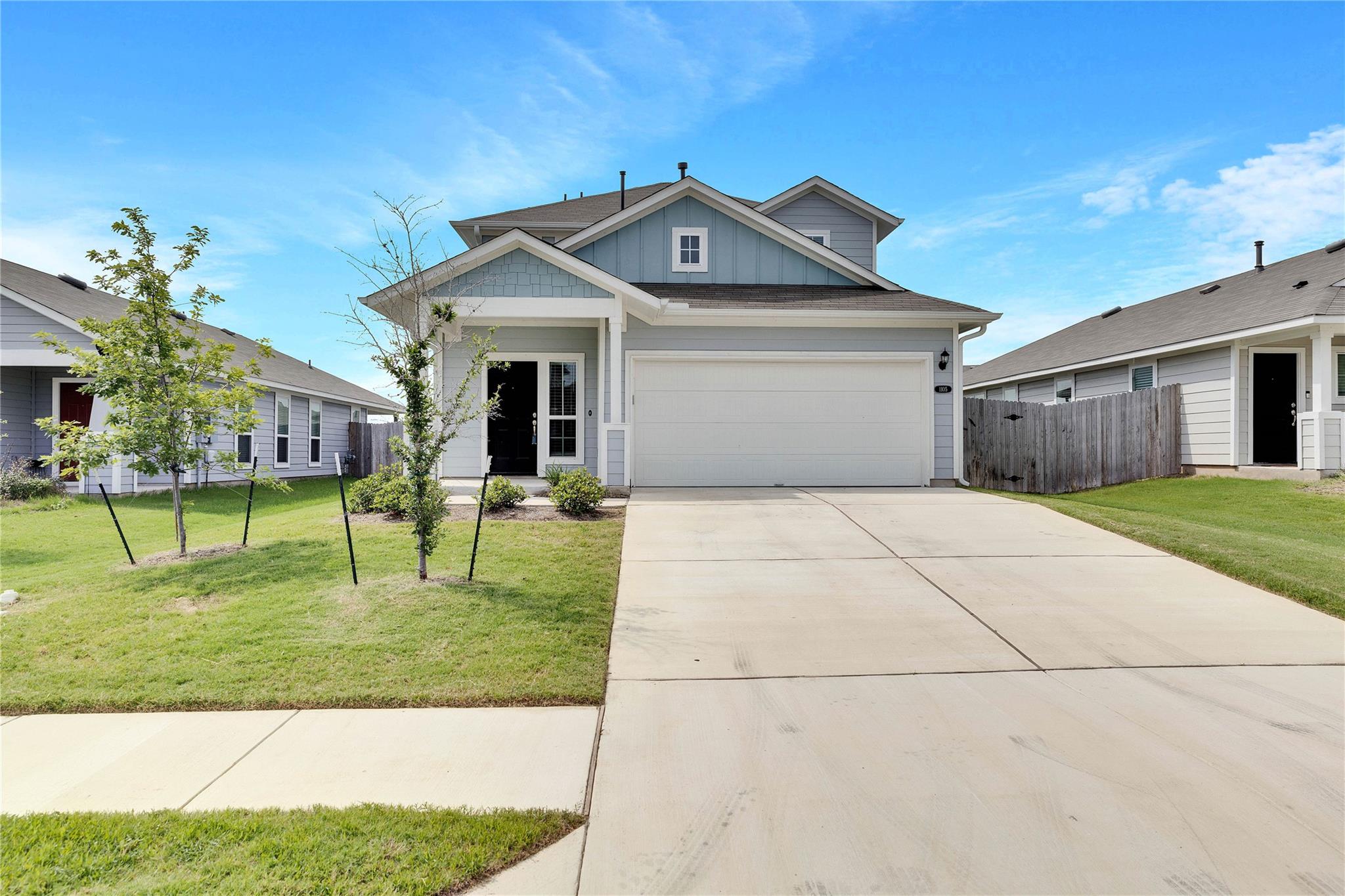 A concrete driveway leads to this two-story home 