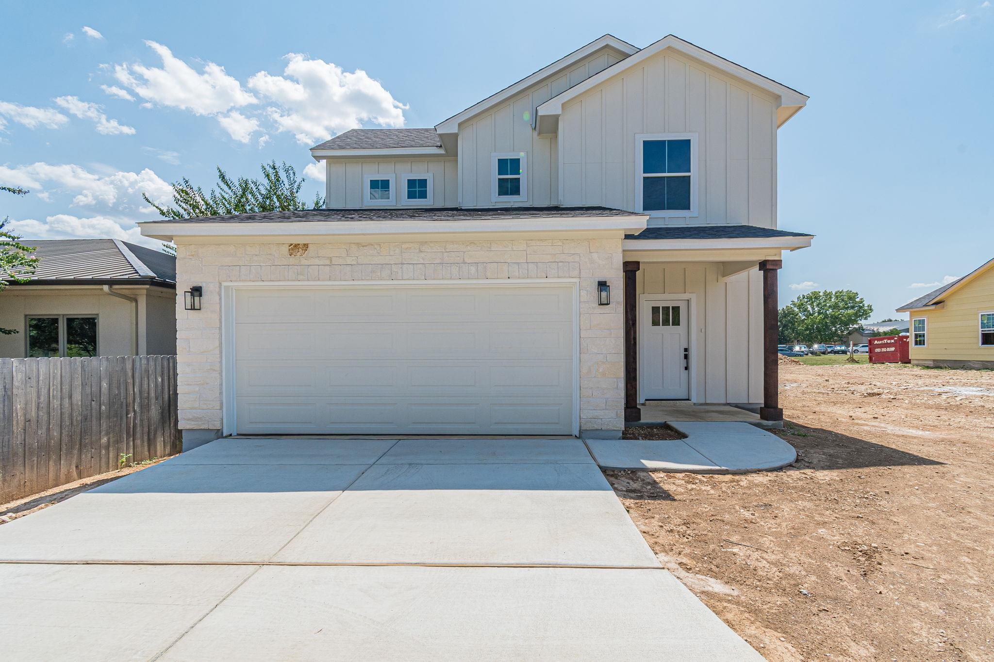 Modern vertical siding and light stone accents el