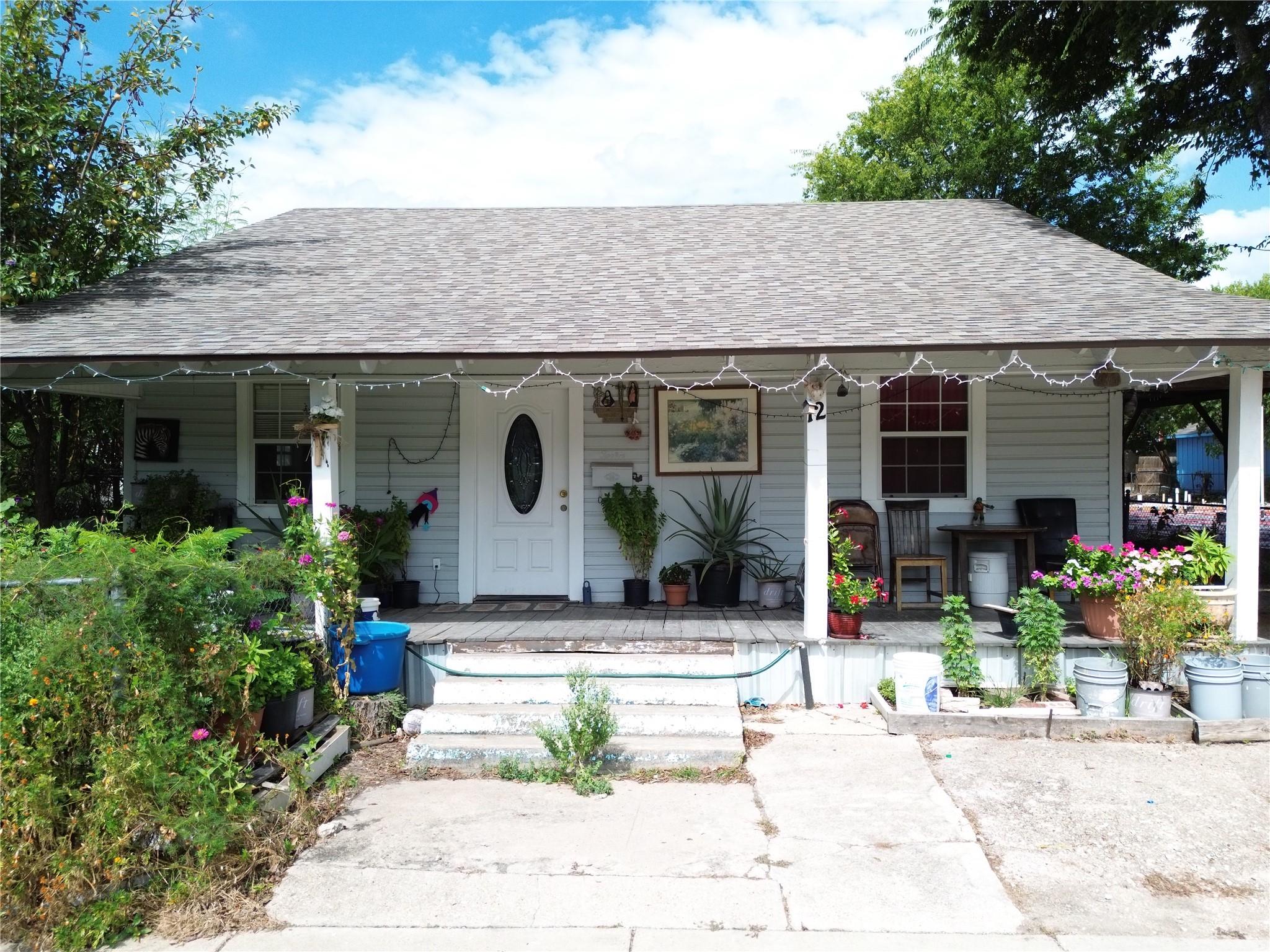 An inviting covered front porch spans the length 