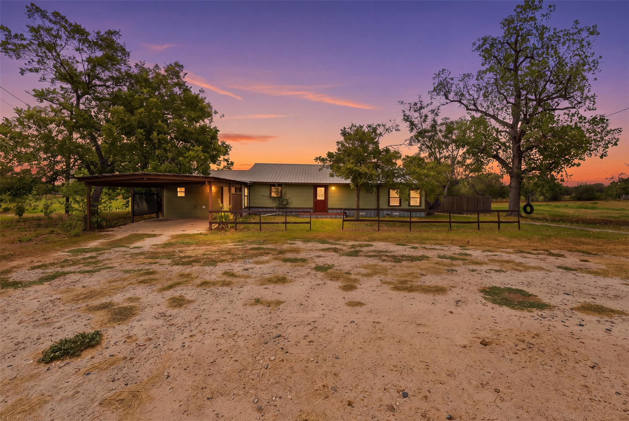 Mature trees frame a classic single-story country