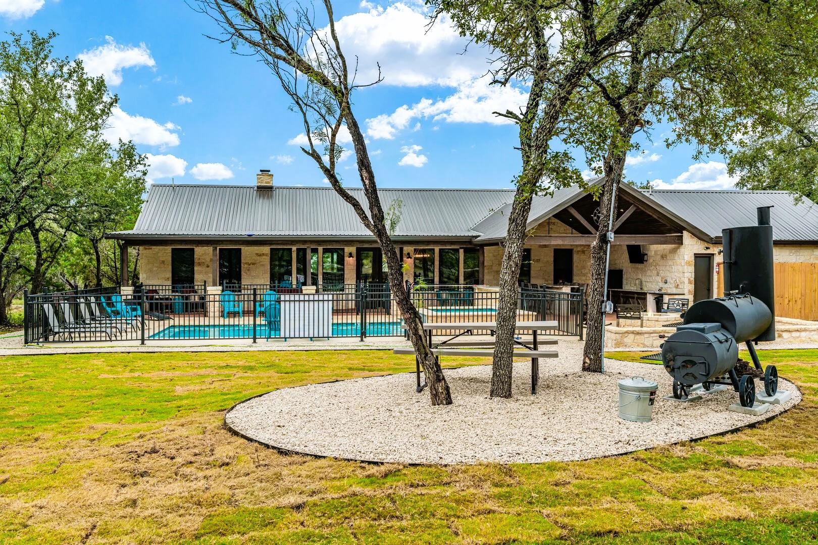 Mature trees shade a spacious lawn leading to an 
