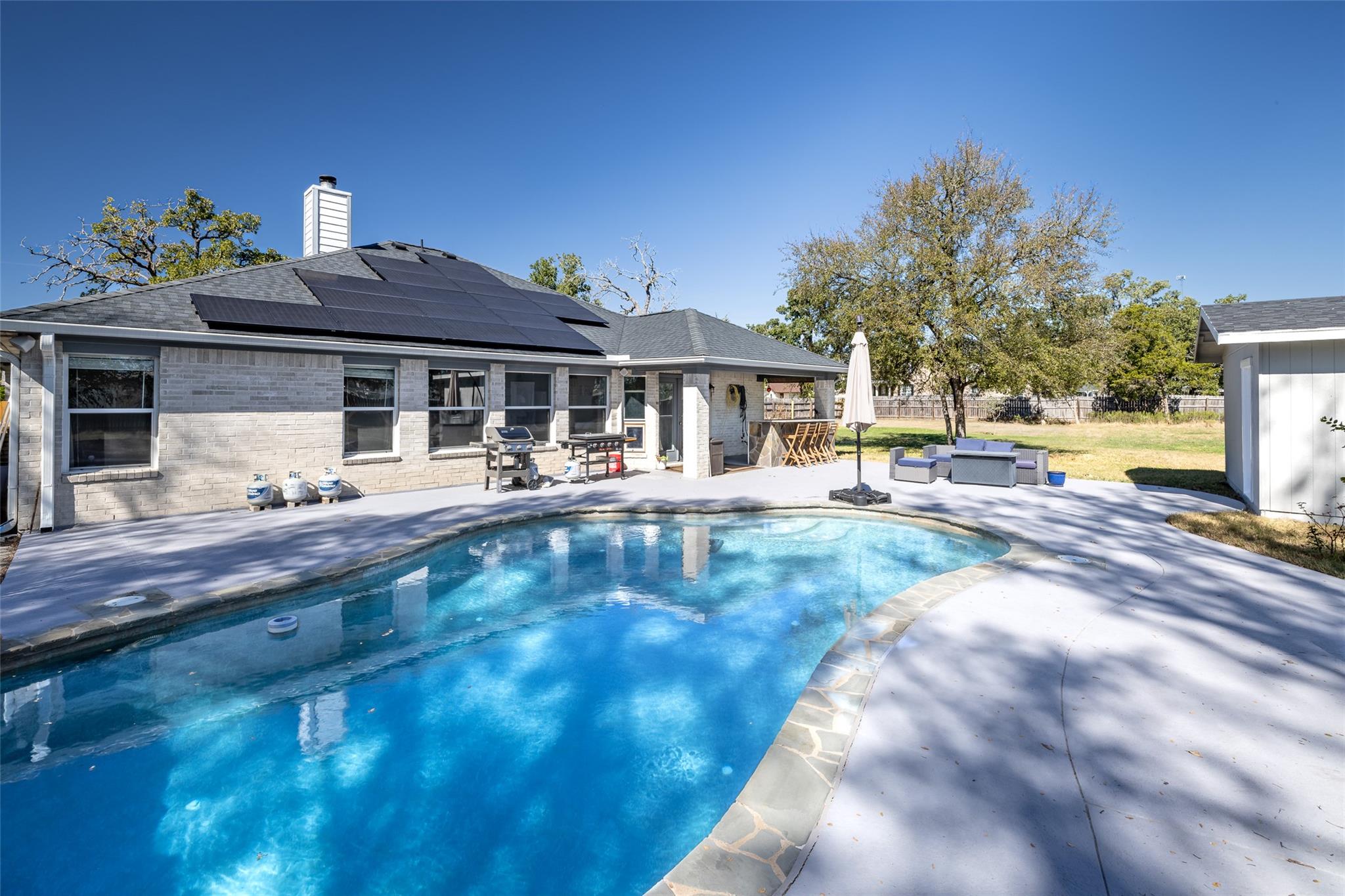 An inviting backyard oasis awaits with a sparklin