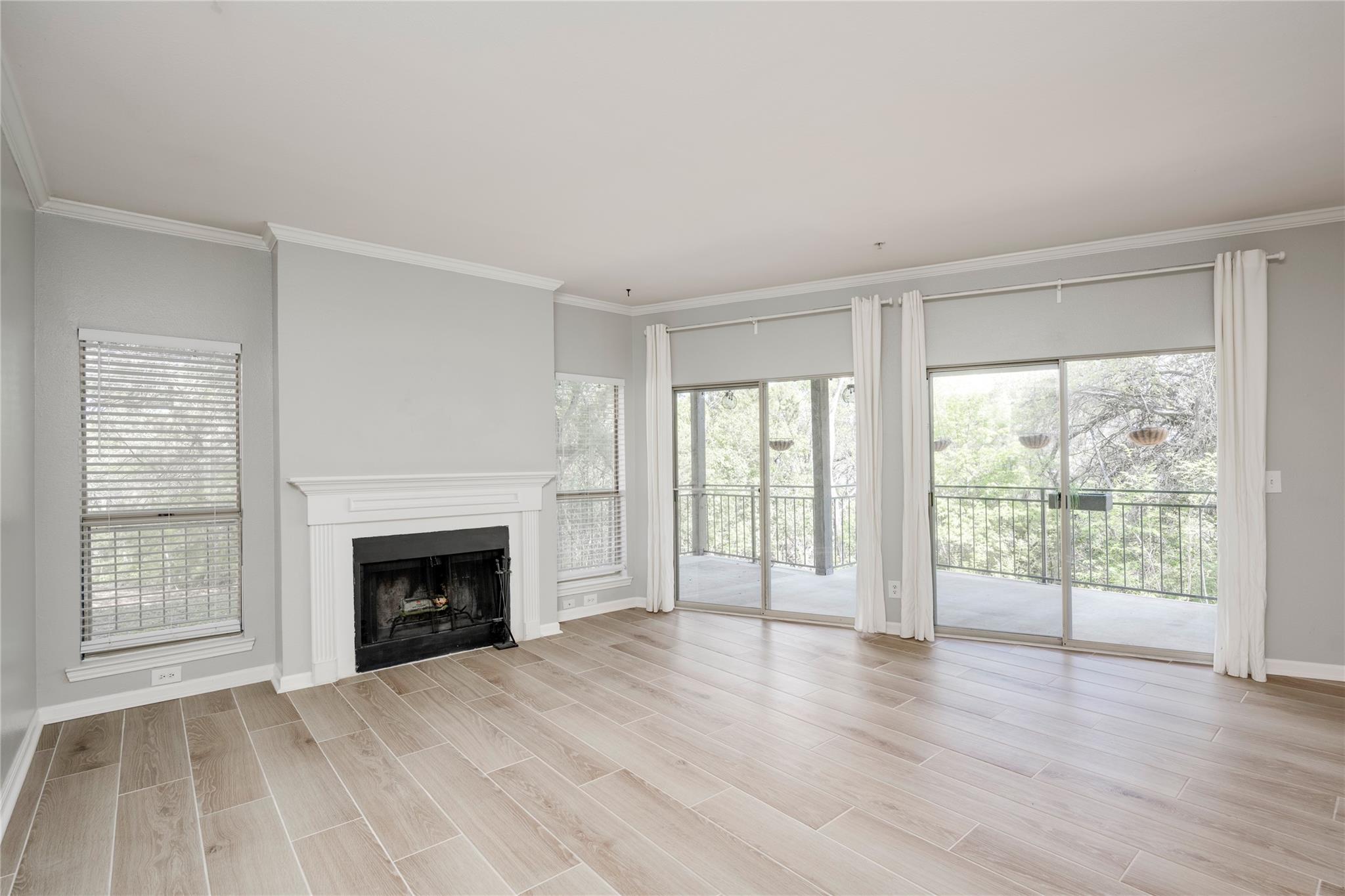 Unfurnished living room featuring wood finish flo