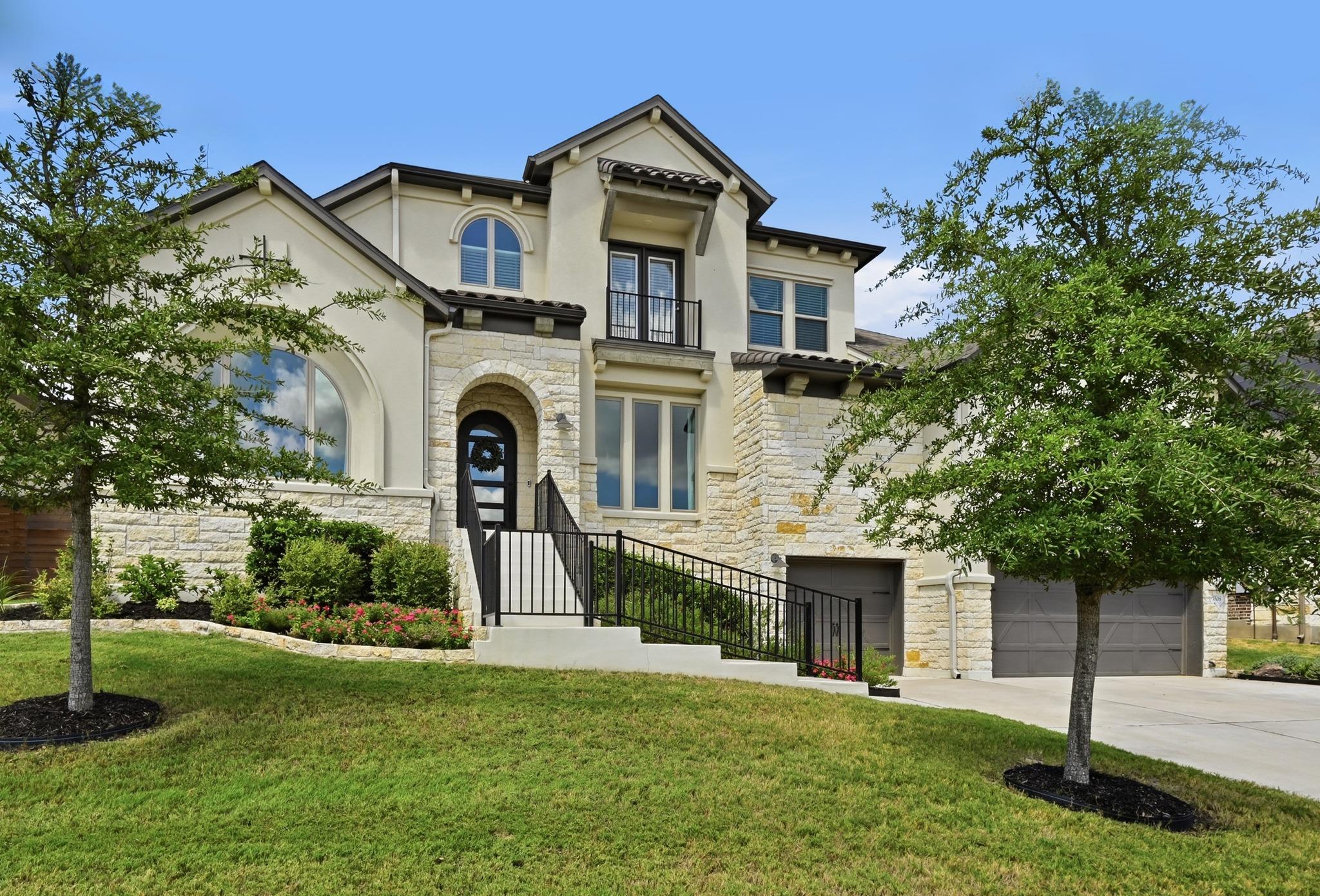 Stately stone and stucco detailing accents this e