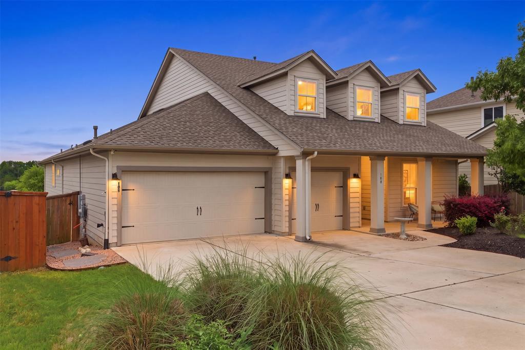 Dormer windows and a covered front porch create c